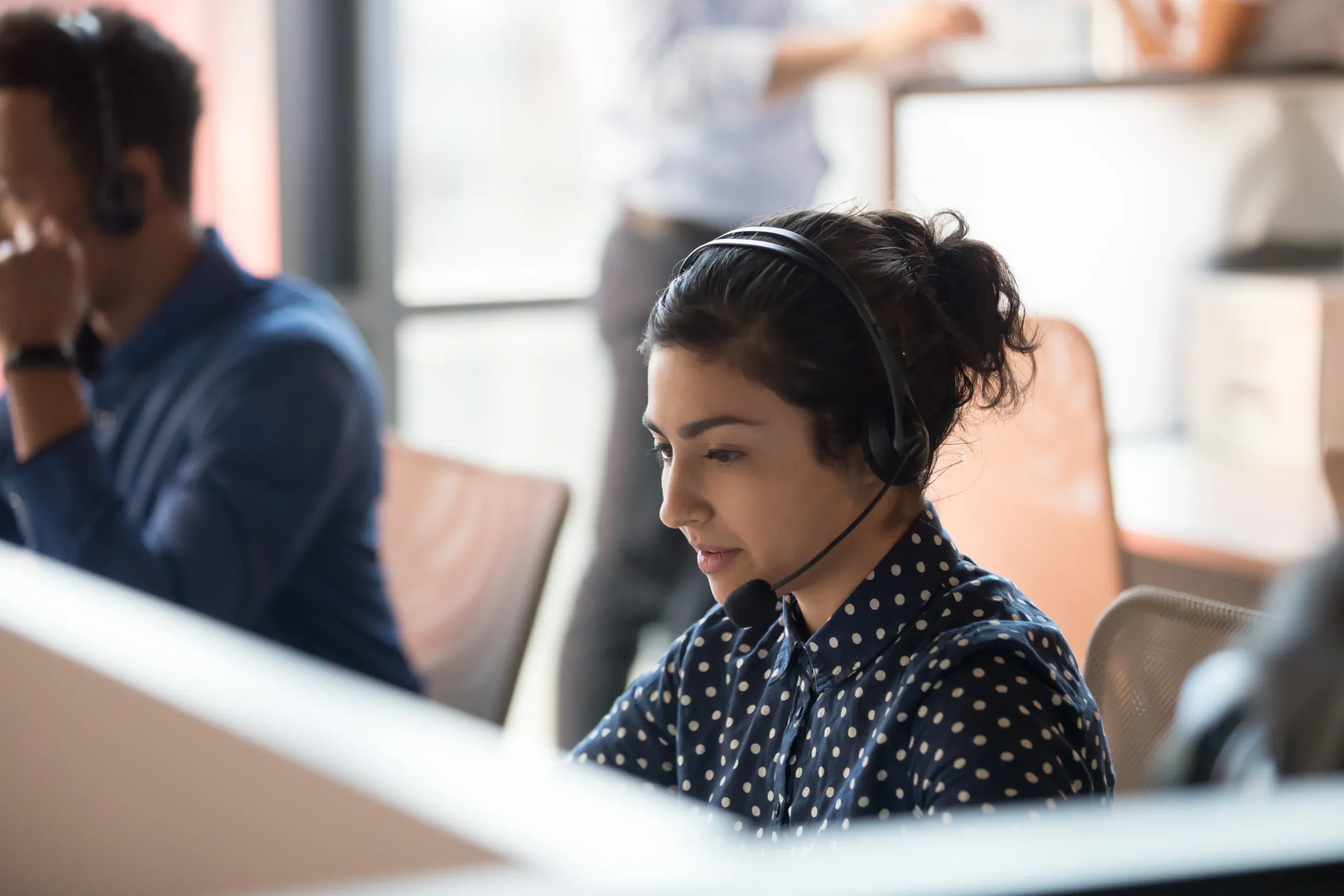 A Carecall247 support team member wearing a headset at the monitoring centre